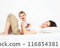 Mother playing with baby on white 116854381