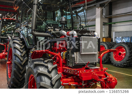 Tractor industry manufacture. New tractors on factory line. Production of agricultural machinery Tractor industry manufacture. New tractors on factory line. Production of agricultural machinery 116855266