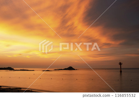 a beach with a beautiful sunrise a beach with a beautiful sunrise 116855532