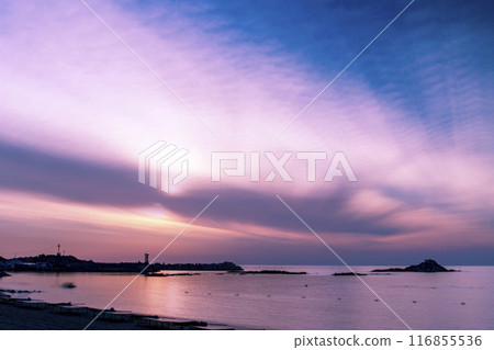 a beach with a beautiful sunrise a beach with a beautiful sunrise 116855536