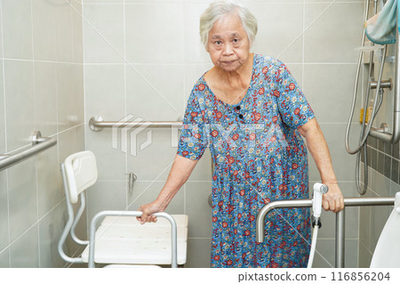 Asian elderly old woman patient use toilet support rail in bathroom, handrail safety grab bar, security in nursing hospital. Asian elderly old woman patient use toilet support rail in bathroom, handrail safety grab bar, security in nursing hospital. 116856204