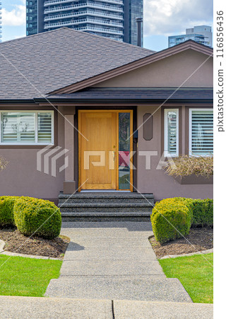 Neat entrance of a family house on residential high-rise buildings background 116856436