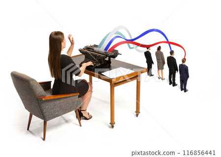 Woman types on vintage typewriter sending colorful streams, in colors of American flag, into heads of small professionals. Woman types on vintage typewriter sending colorful streams, in colors of American flag, into heads of small professionals. 116856441