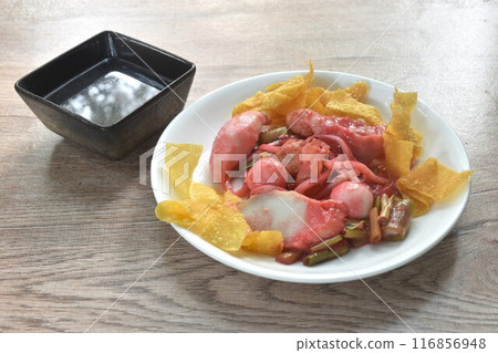 dry steamed fish and shrimp ball couple dumpling topping pickled cuttlefish dressing red soybean sauce on plate with soup dry steamed fish and shrimp ball couple dumpling topping pickled cuttlefish dressing red soybean sauce on plate with soup 116856948