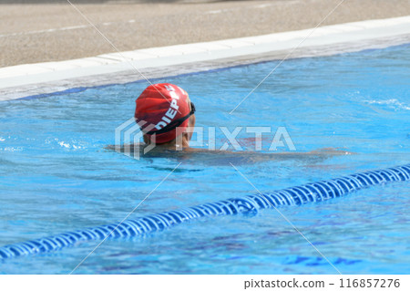 A swimmer in a red cap swims in the Dieppe pool A swimmer in a red cap swims in the Dieppe pool 116857276