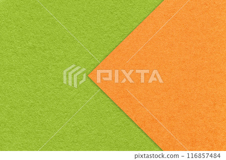 Texture bright green paper background, half two colors with orange arrow, macro. Craft cardboard. Texture bright green paper background, half two colors with orange arrow, macro. Craft cardboard. 116857484