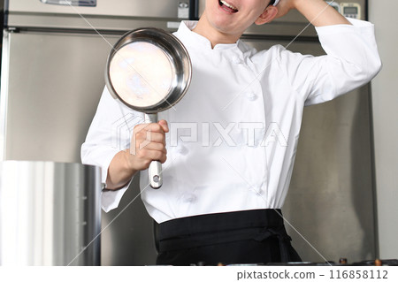 Young Asian male chef worried in the kitchen Young Asian male chef worried in the kitchen 116858112