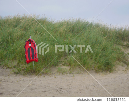 Life saving rescue board on the beach in Skagen. Lifeguard preserving buoy for self-usage. The concept of safety on water. 116858331