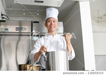 Young asian male chef preparing food in the kitchen 116858333
