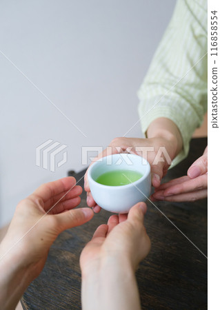 A middle-aged woman preparing tea for guests A middle-aged woman preparing tea for guests 116858554