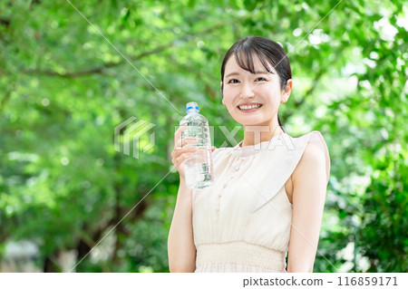 一位女士在新鮮的綠色植物中補充水分 一位女士在新鮮的綠色植物中補充水分 116859171