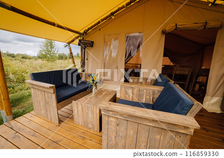 Interior of cozy open glamping tent. Camping tent for outdoor summer holiday and vacation 116859330