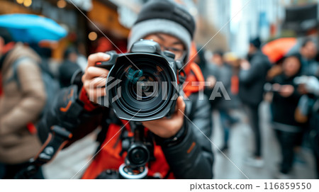 Photographer Holding Camera in Busy Street Photographer Holding Camera in Busy Street 116859550