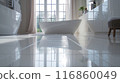 The bathroom floor is sparkling clean, Shiny white bathroom floor. 116860049