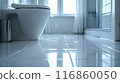 The bathroom floor is sparkling clean, Shiny white bathroom floor. 116860050