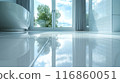 The bathroom floor is sparkling clean, Shiny white bathroom floor. 116860051