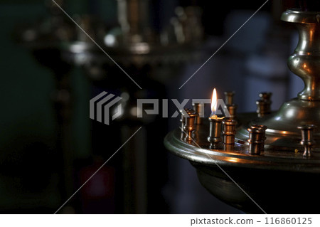 Traditional church lamp with candles in the Orthodox Church, close-up, copy space, selective focus. Traditional church lamp with candles in the Orthodox Church, close-up, copy space, selective focus. 116860125