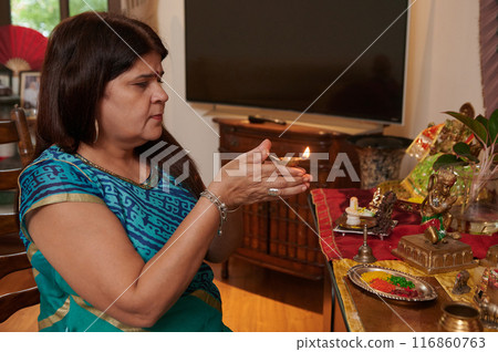 Woman Lightning Candle At Altar 116860763