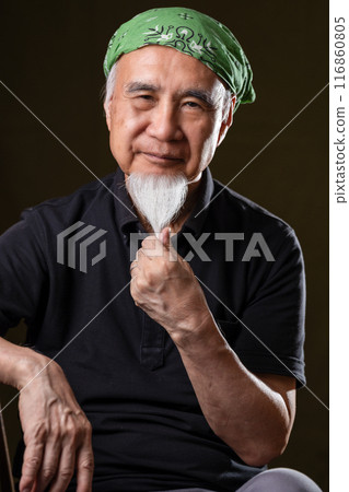 Senior man in his 60s or 70s with a white beard enjoying senior life 116860805