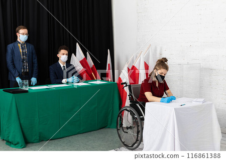 A wheelchair teenager completes an electoral ballot in a vote for the President of Poland. 116861388