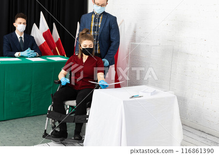 A young adult in a wheelchair came to the polling station to vote for president in the elections in Poland. 116861390