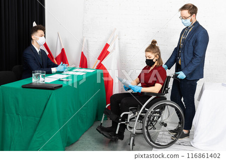 A young adult in a wheelchair came to the polling station to vote for president in the elections in Poland. A young adult in a wheelchair came to the polling station to vote for president in the elections in Poland. 116861402