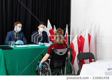 A young adult in a wheelchair came to the polling station to vote for president in the elections in Poland. A young adult in a wheelchair came to the polling station to vote for president in the elections in Poland. 116861436