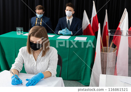 A teenager entitled to vote sits at a polling station and fills out a ballot paper for the President of Poland. A teenager entitled to vote sits at a polling station and fills out a ballot paper for the President of Poland. 116861521