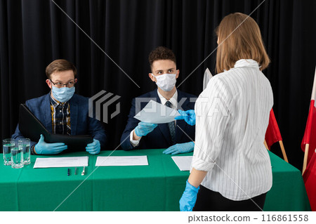The electoral commission sits and waits for those entitled to vote for the President of Poland. The electoral commission sits and waits for those entitled to vote for the President of Poland. 116861558