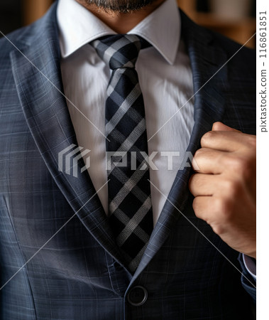 Close-up of suit-clad man with checkmark flag, symbolizing achievement. 116861851