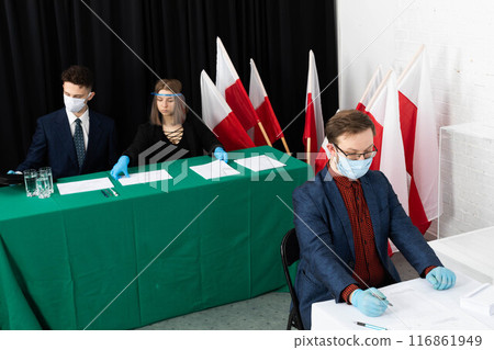 The voter sat down to the table and begins to mark his ideal presidential candidate. The voter sat down to the table and begins to mark his ideal presidential candidate. 116861949