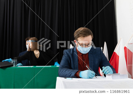 The voter sat down to the table and begins to mark his ideal presidential candidate. 116861961