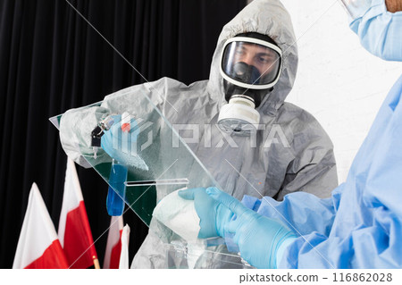 Two employees disinfect the ballot box before the presidential election in Poland. 116862028