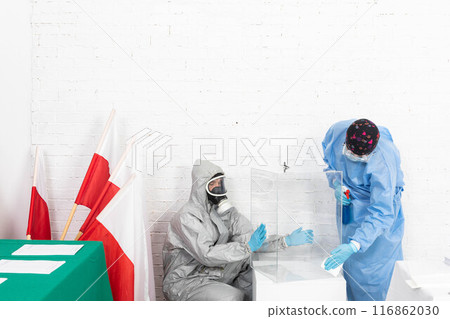 Two employees disinfect the ballot box before the presidential election in Poland. 116862030