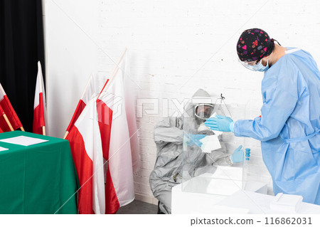 Two employees disinfect the ballot box before the presidential election in Poland. 116862031