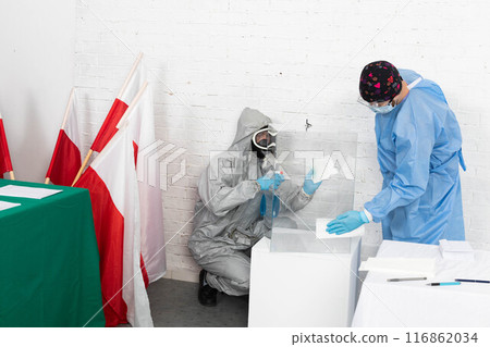 Two employees disinfect the ballot box before the presidential election in Poland. 116862034