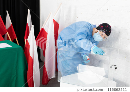 The employee during disinfection tries to thoroughly clean every inch of the ballot box to avoid infection. 116862211