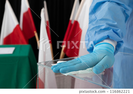 The employee during disinfection tries to thoroughly clean every inch of the ballot box to avoid infection. 116862221