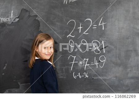 In the maths lesson the student turns to the class and shows the results of the tasks she completed. In the maths lesson the student turns to the class and shows the results of the tasks she completed. 116862269