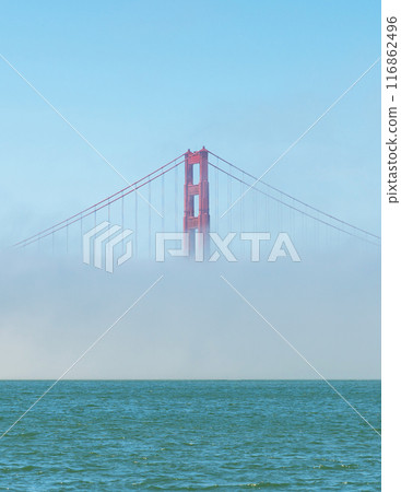 Golden Gate Bridge in a foggy weather. Only one tower is visible because of the fog. The Golden Gate Bridge is a suspension bridge spanning the Golden Gate 116862496