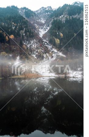 Autumn landscape with a reflection lake and a bit snow in Artvin rurals, Turkey. Vast autumn scenery with seasonal colors in Black Sea region Autumn landscape with a reflection lake and a bit snow in Artvin rurals, Turkey. Vast autumn scenery with seasonal colors in Black Sea region 116862515