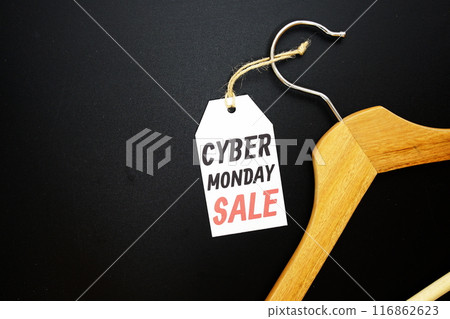 Cyber Monday Sale on price tag with wooden clothes hanger top view on black background Cyber Monday Sale on price tag with wooden clothes hanger top view on black background 116862623