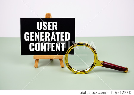 User Generated Content text on paper card with magnifying glass on green background 116862728