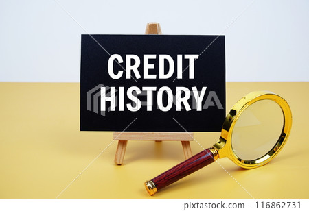 Credit History text on paper card with magnifying glass on yellow background Credit History text on paper card with magnifying glass on yellow background 116862731
