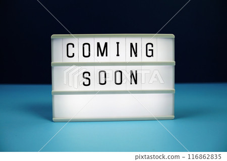 Coming Soon letterboard text on LED Lightbox on blue background Coming Soon letterboard text on LED Lightbox on blue background 116862835
