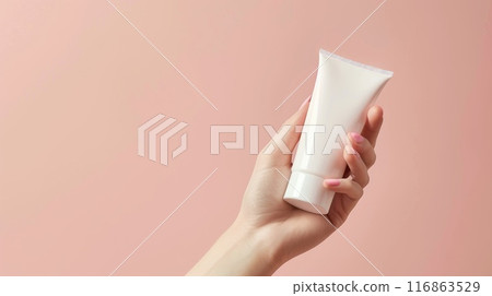 Cream and body lotion banner featuring woman's hand holding blank tube on pastel background with copy space 116863529
