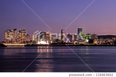 Montreal illuminated new skyline, including recently added skyscrapers, reflected in the St. Lawrence River at dusk, Quebec, Canada Montreal illuminated new skyline, including recently added skyscrapers, reflected in the St. Lawrence River at dusk, Quebec, Canada 116863602