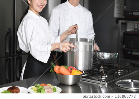 Young asian male and female chefs cooking in the kitchen 116863778