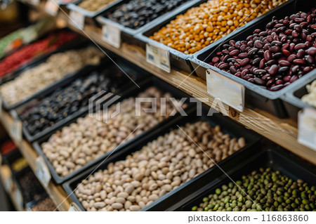 Variety of Beans and Pulses Displayed on shelf in grocery store in a Supermarket Bulk Section 116863860