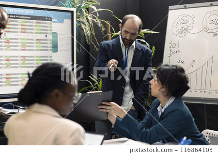 Chairman of the board reviews potential enterprise expansion, team supervisor and the members look into data visualizations. Forecast affiliates seek to boost organizational earnings. 116864103